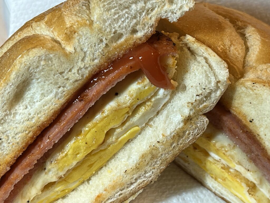 Close-up of a bacon, egg, and cheese sandwich.