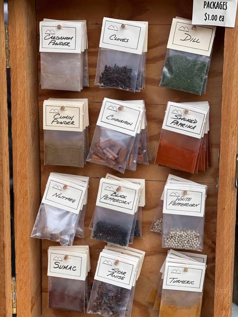 Assorted spices in packets for sale.