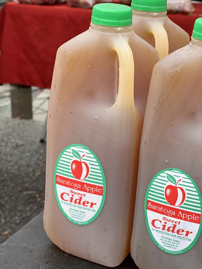 Plastic jugs of Saratoga Sweet Apple Cider.