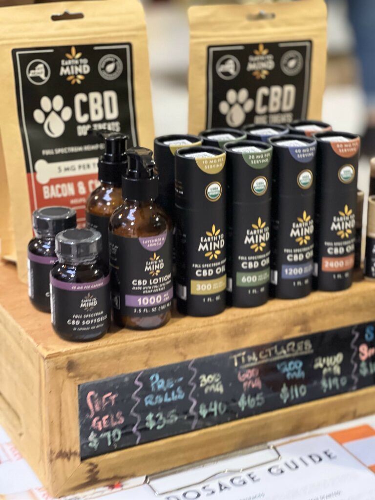 Assorted CBD products on display with pricing information.