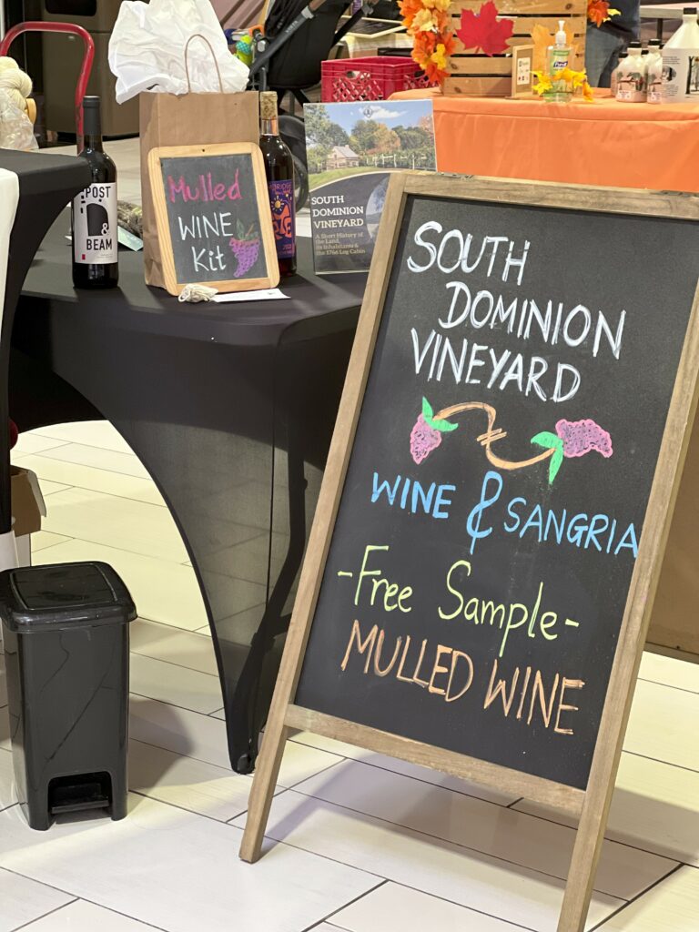 Wine tasting event with mulled wine free sample sign.