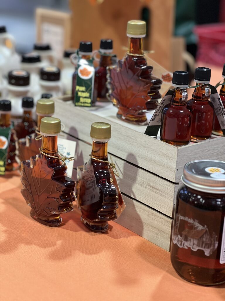 Various maple syrup bottles on display.