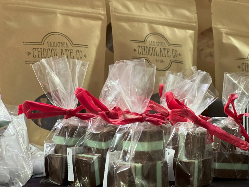 Saratoga Chocolate Co. branded packaged chocolates with red bows