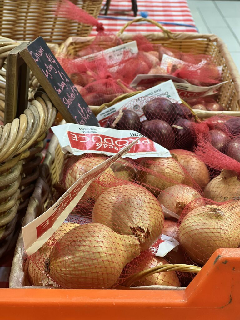 Fresh onions for sale in produce section.