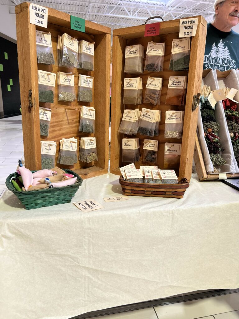 Herb and spice packets displayed on wooden racks.
