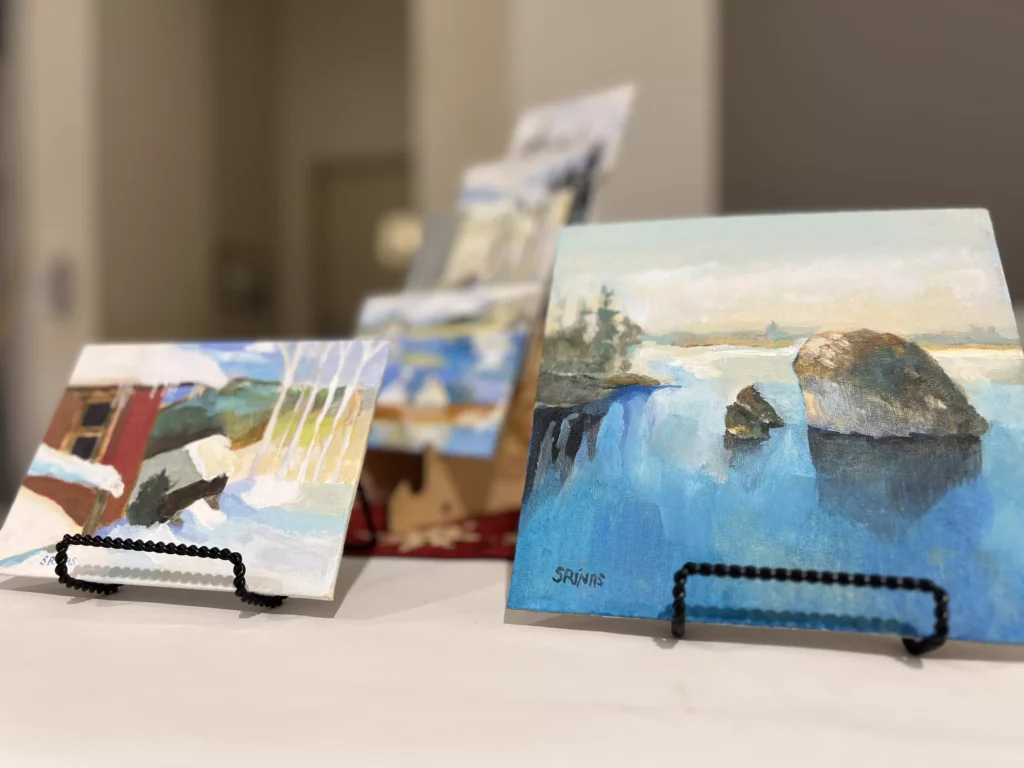 Miniature paintings on easel displays.