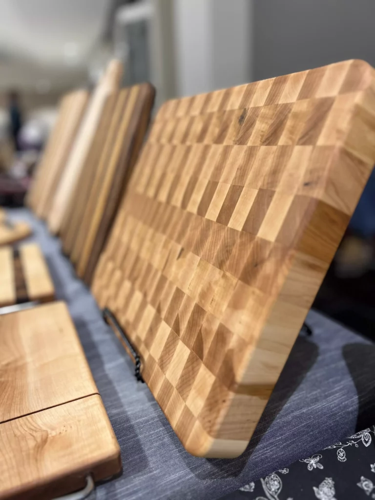 Wooden cutting boards on display at market.