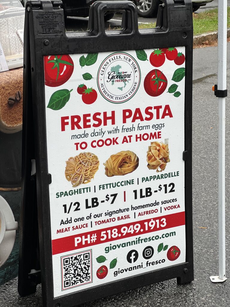 Fresh homemade pasta sign with prices and contact info.