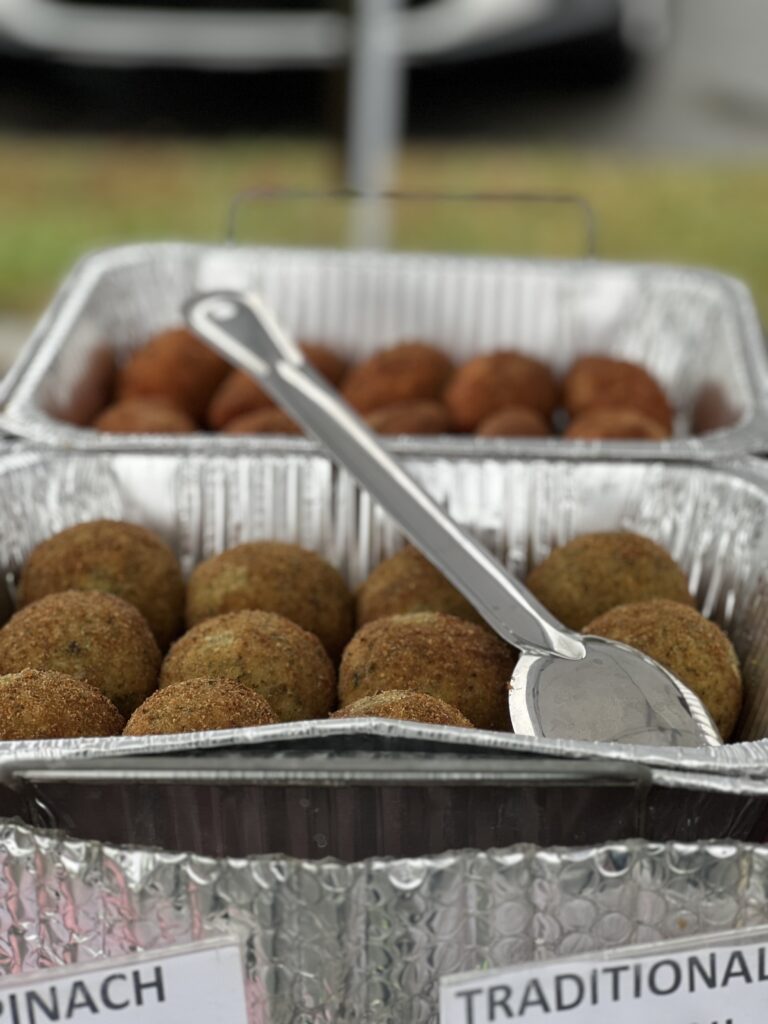 Catering trays with falafel and hushpuppies at event.