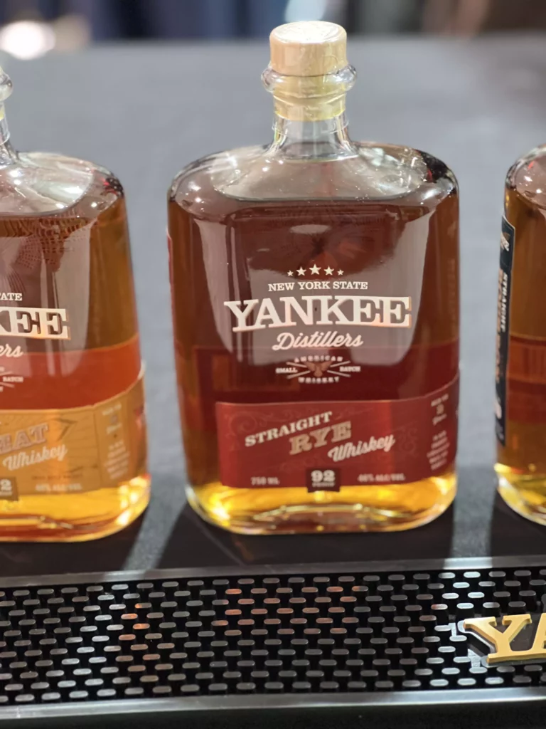 Three bottles of Yankee straight rye whiskey.