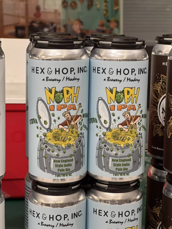 Hex & Hop Brewery IPA beer cans on shelf.