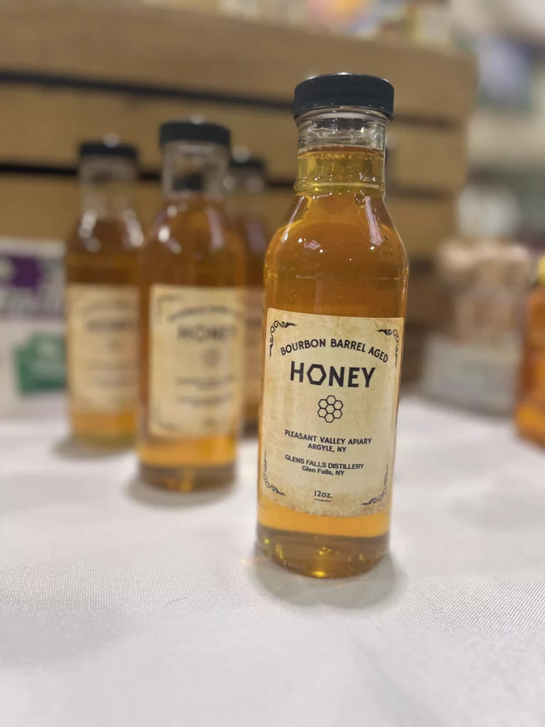 Bourbon barrel-aged honey bottle on display.