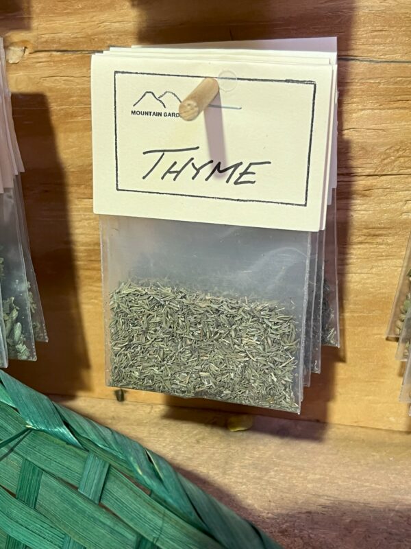 Dried thyme displayed in clear dispensing container.