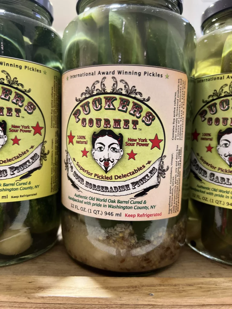 Gourmet pickled cucumbers in labeled jars.