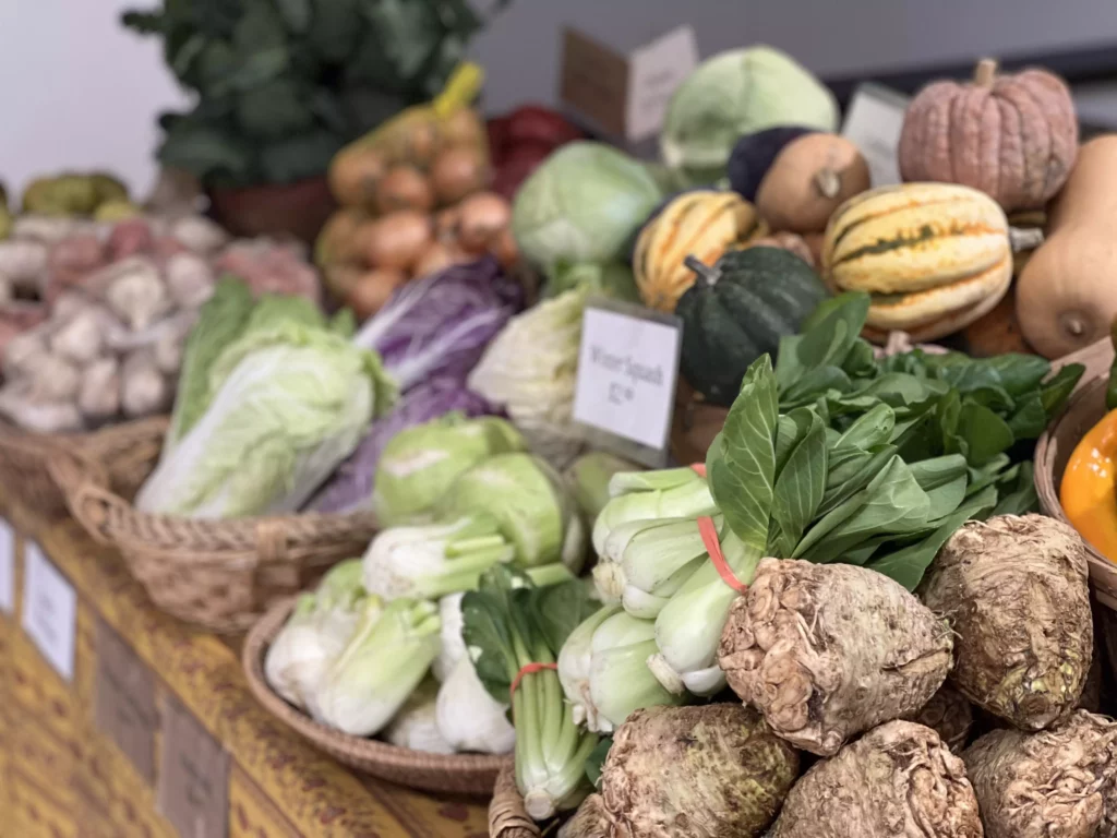 Fresh vegetables displayed in baskets at market.